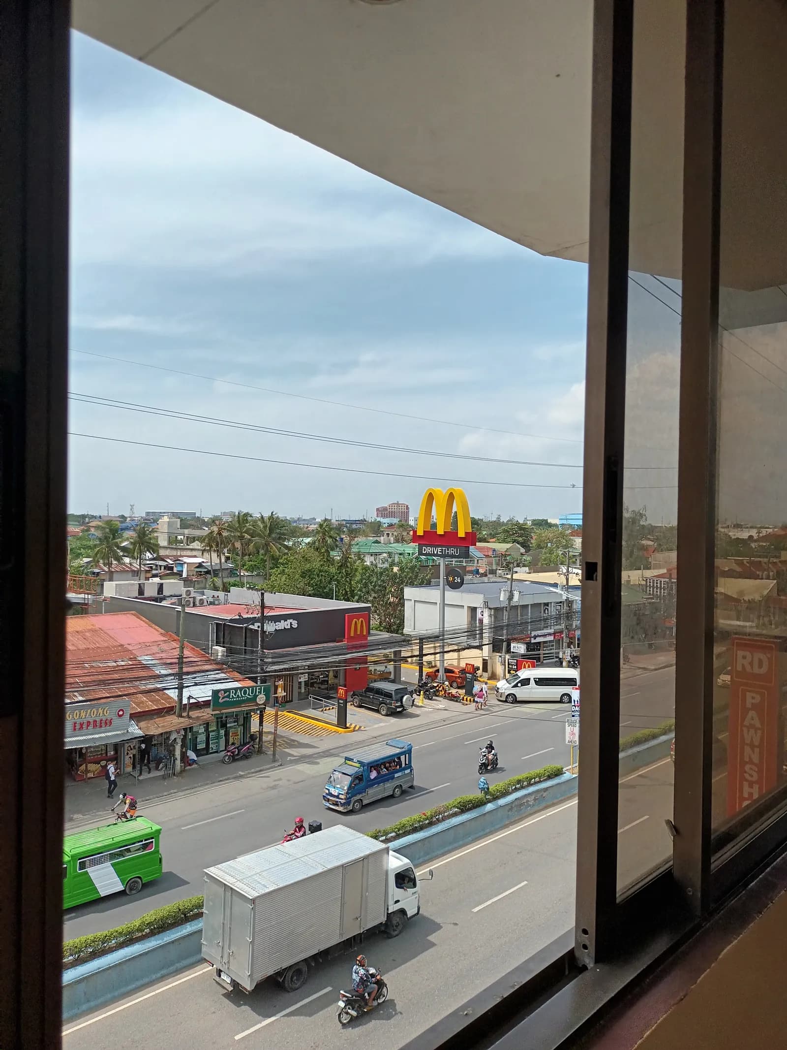 View of the M.L. Quezon Highway and shops from the hotel