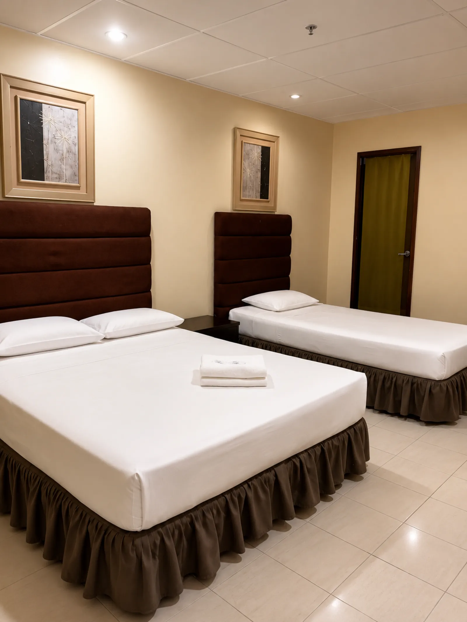 Comfortable guest room with double and single beds at Mactan Pension House